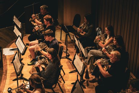 Close up image of the French Horn section of Tees Valley Youth Orchestra rehearsing