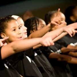 children pointing in a performance