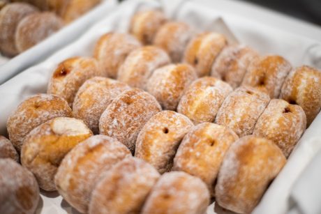A tray of jam doughnuts covered with sugar