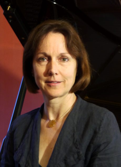 Esther Cavett looking at the camera, with short brown hair and a black blouse.