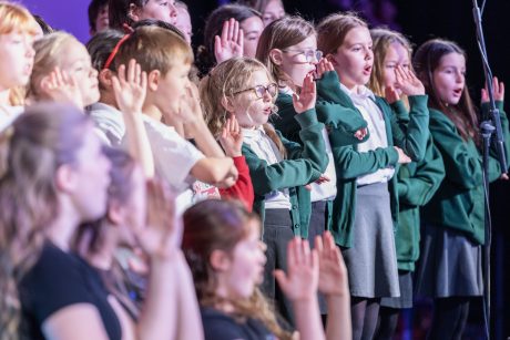 Young people singing and dancing on stage
