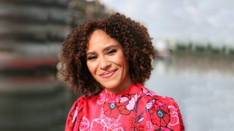 Photograph of Natasha Hendry looking towards camera, in front of a blurred background of a river.