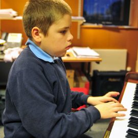 boy plays piano