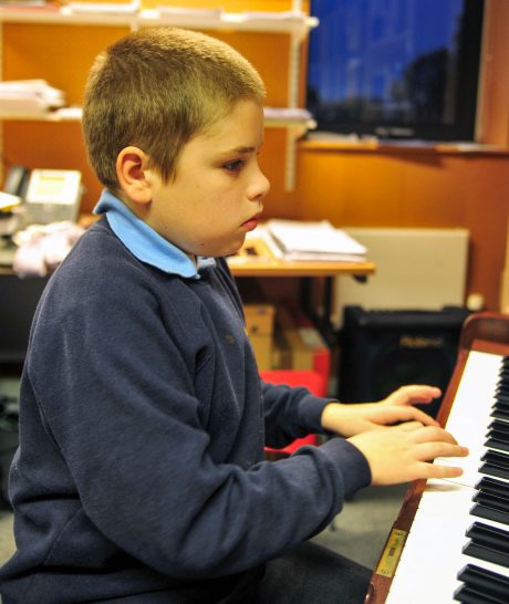boy plays piano