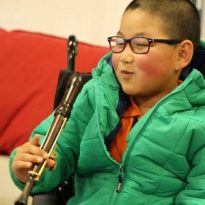 Disabled children learn on adapted musical instruments in S4E Music Service programme