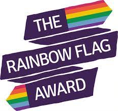 A purple banner reading 'The Rainbow Flag Award' with rainbows at each end of the banner