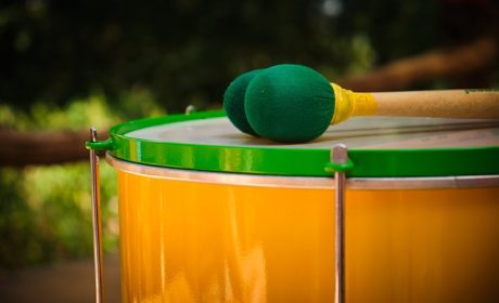 Yellow Brazilian surdo drum with green beaters 