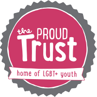 Pink circle with white text reading 'The Proud Trust' surrounded by a grey circle with spikes. White banner across the front with pink text reading 'Home of LGBT+ youth'